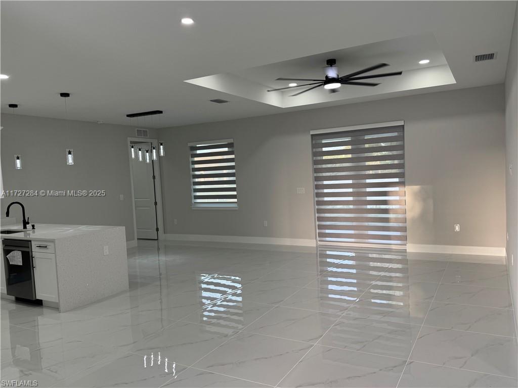 2902 49th Street Southwest Lehigh Acres, FL 33976 - Photo 10 of 26 a view of a livingroom with a lounge chair and a ceiling fan