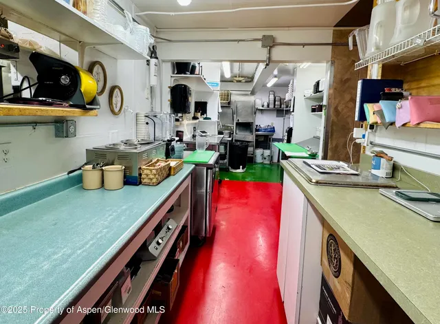 a utility room with stainless steel appliances kitchen island a stove and a microwave