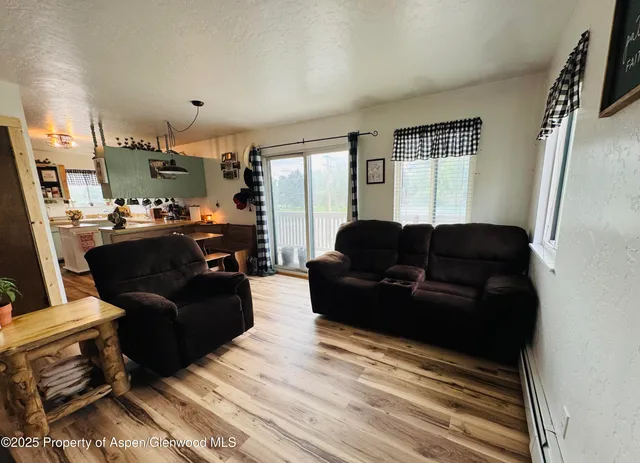 a living room with furniture fireplace and a large window