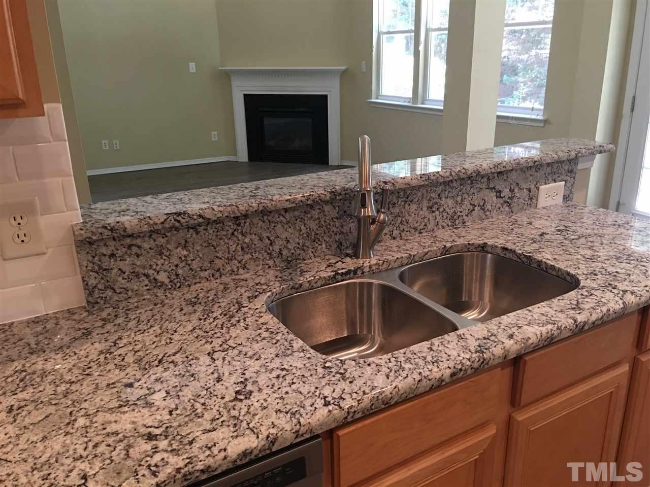 8504 Pillar Gate Lane Raleigh, NC 27613 - Photo 8 of 25 a kitchen with granite countertop a sink and a window