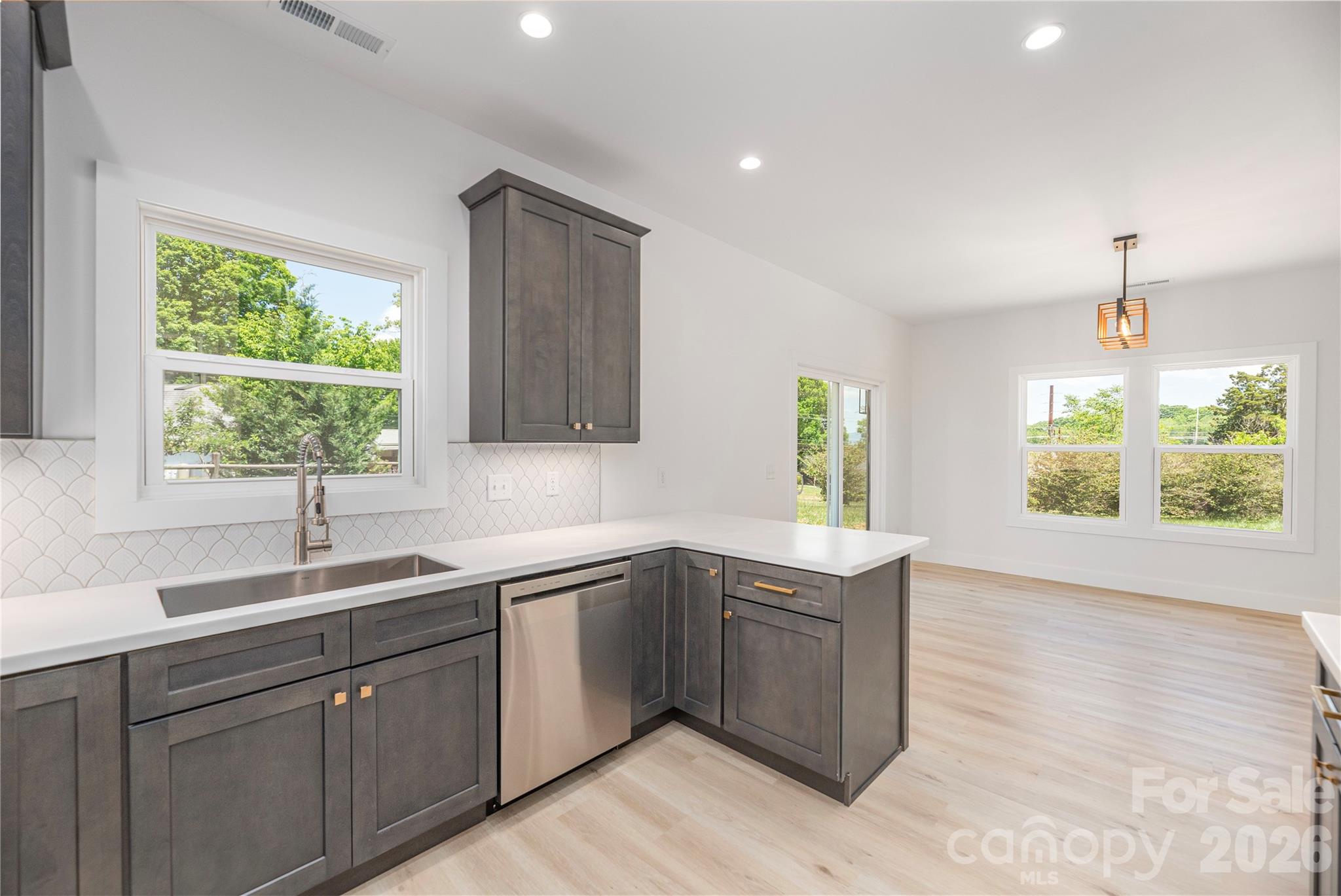 32 Oak Hill Road Candler, NC 28715 - Photo 13 of 29 a kitchen with a sink window and cabinets