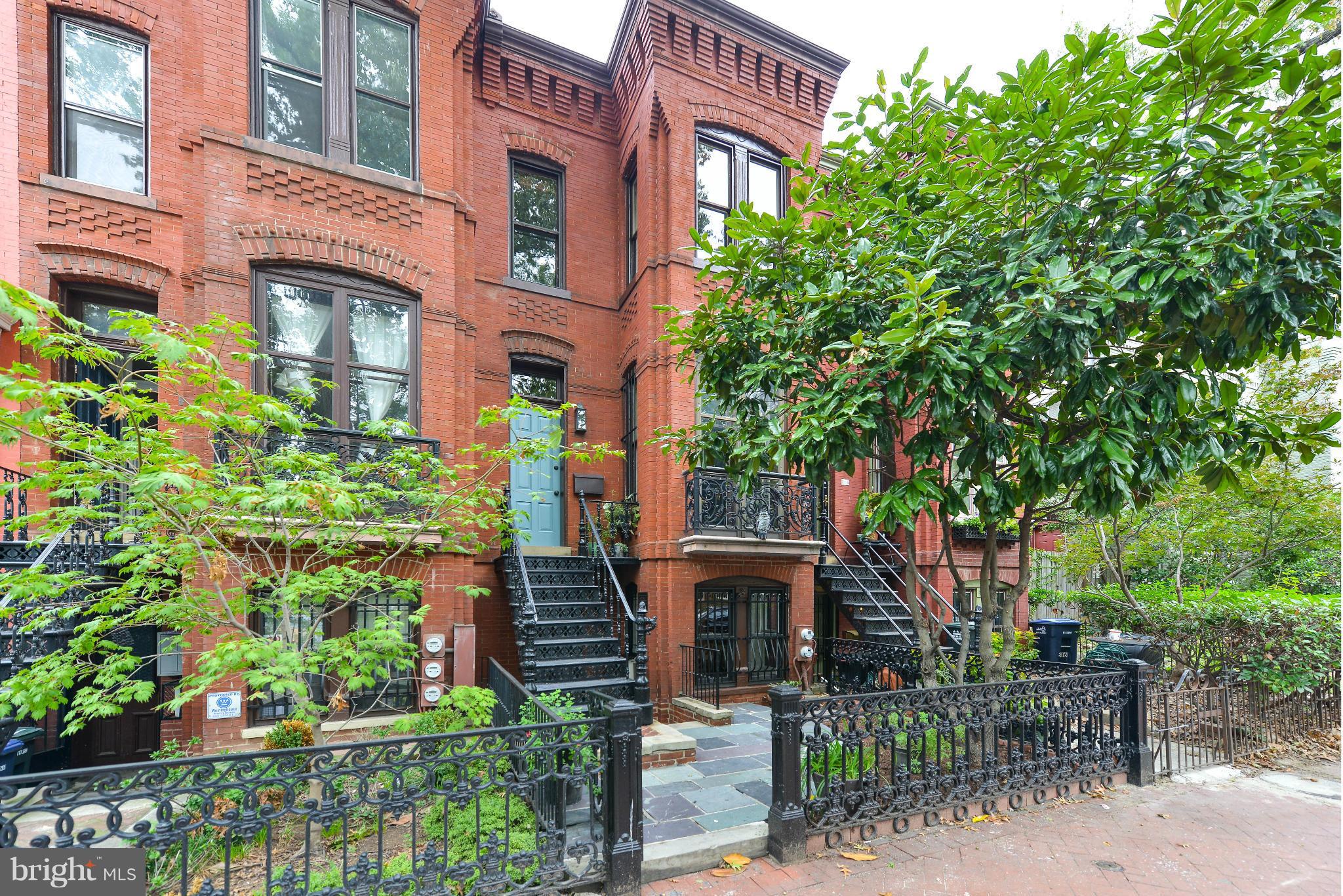 a front view of a multi story residential apartment building with a yard