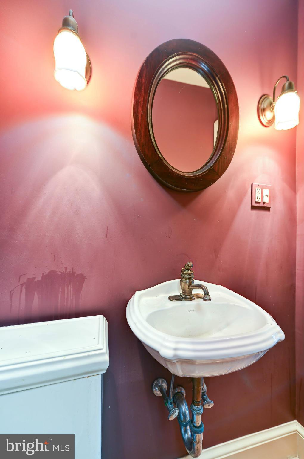 814 E Street Southeast Washington, DC 20003 - Photo 11 of 30 a bathroom with a sink a toilet and a mirror