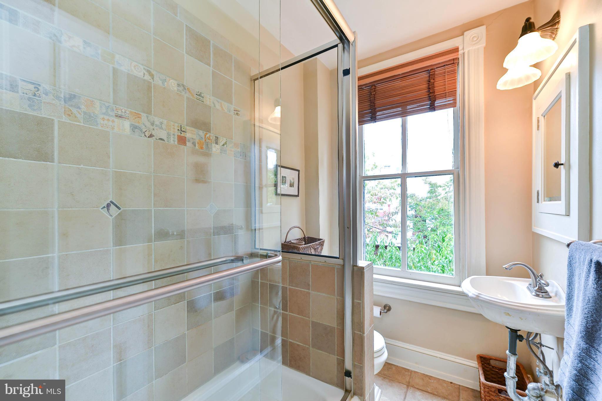 814 E Street Southeast Washington, DC 20003 - Photo 14 of 30 a bathroom with a bathtub and a shower