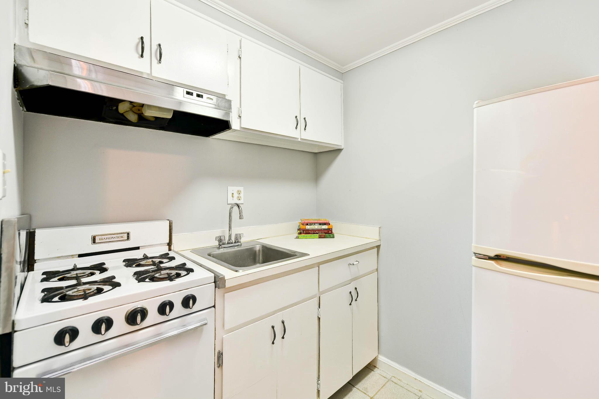 814 E Street Southeast Washington, DC 20003 - Photo 19 of 30 a kitchen with stainless steel appliances a stove a microwave and cabinets