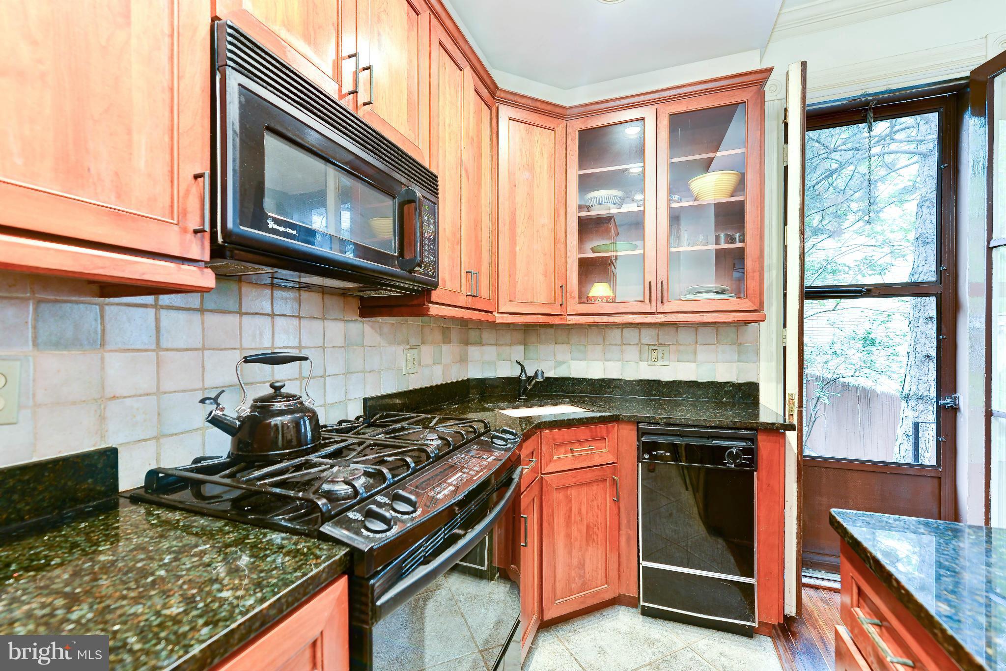 814 E Street Southeast Washington, DC 20003 - Photo 8 of 30 a kitchen with stainless steel appliances granite countertop a stove and a microwave