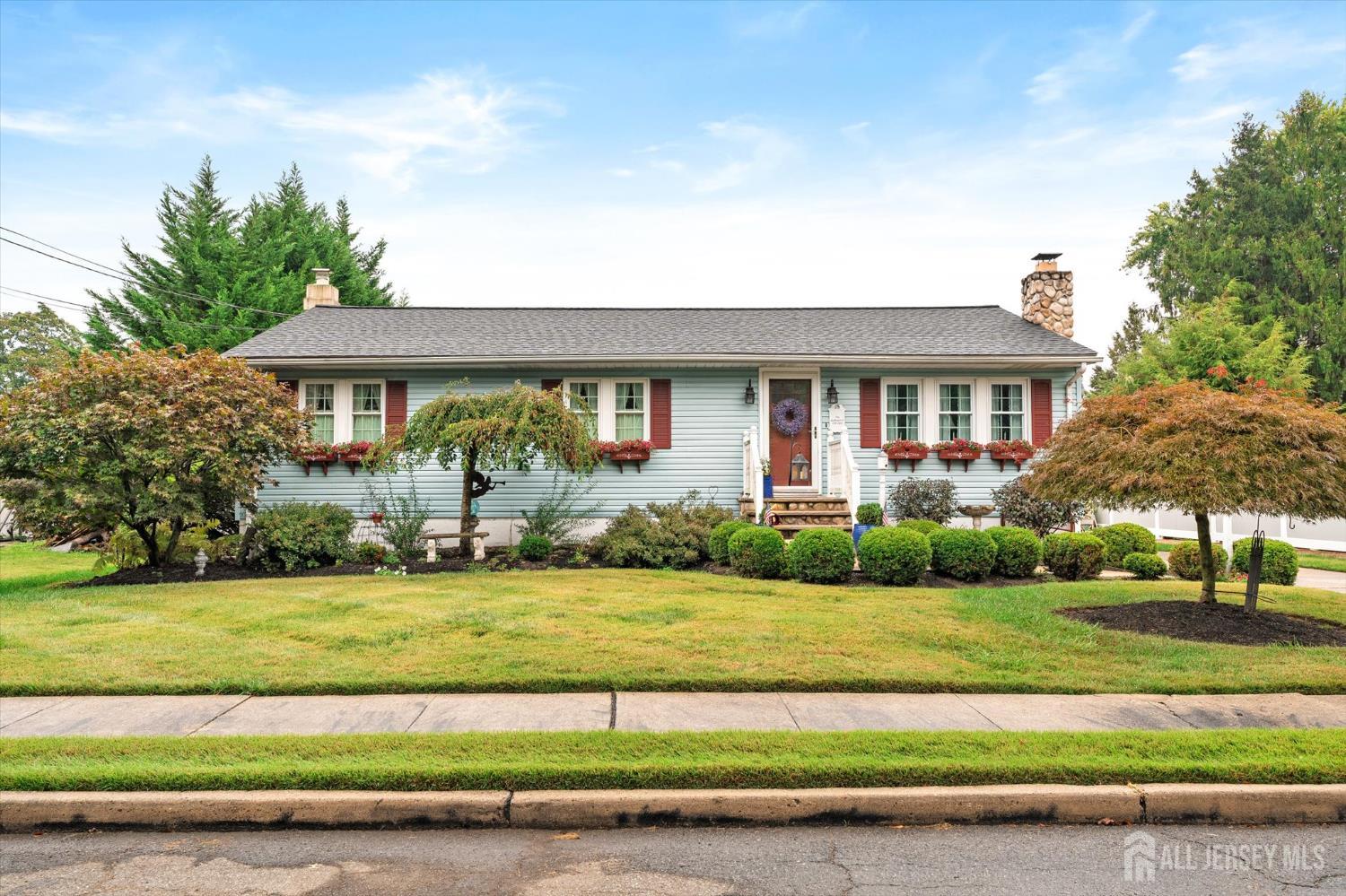 a front view of a house with a garden