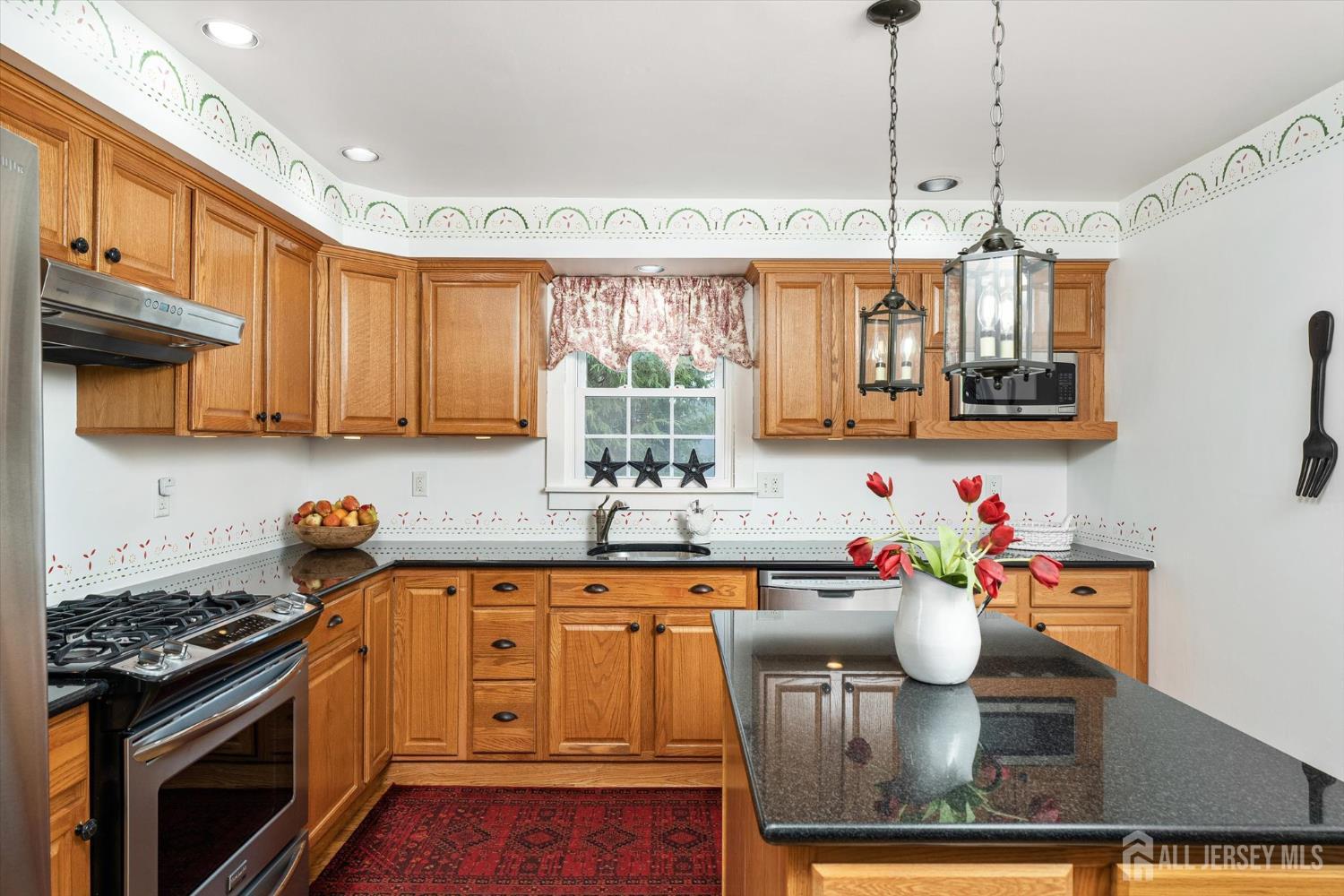 66 Rutgers Avenue Hamilton, NJ 08619 - Photo 11 of 31 a kitchen with stainless steel appliances granite countertop a stove a sink and a microwave