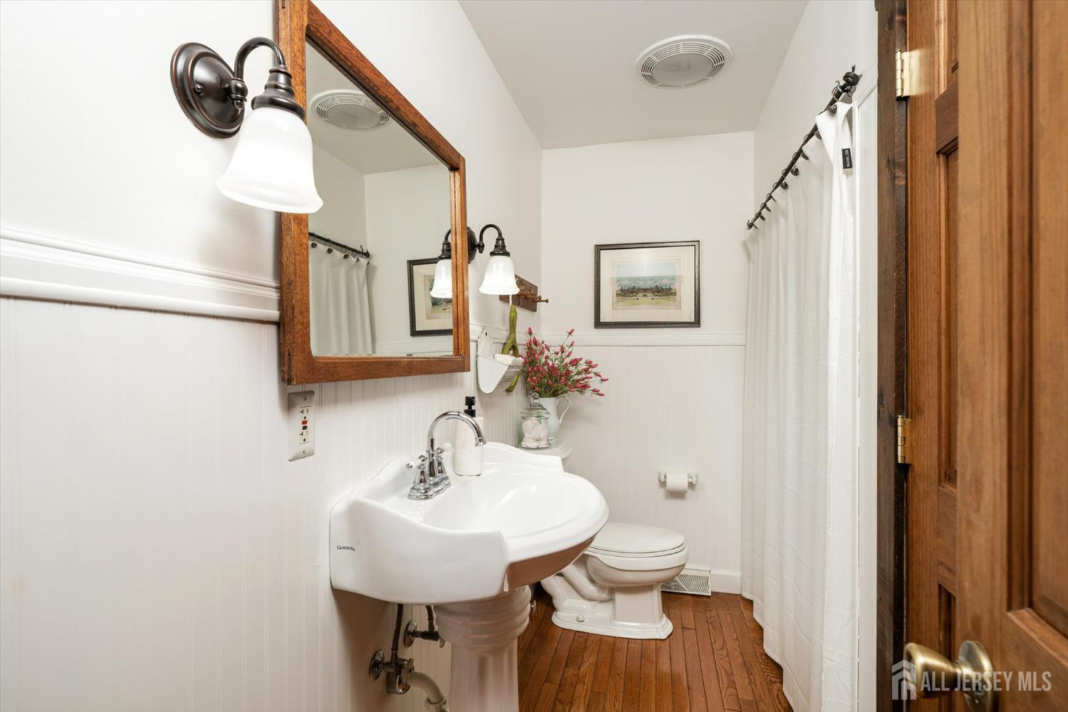 66 Rutgers Avenue Hamilton, NJ 08619 - Photo 16 of 31 a bathroom with a sink a mirror and a toilet