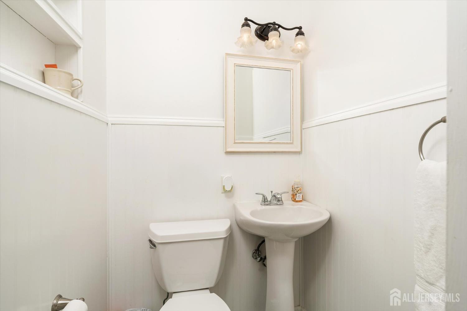 66 Rutgers Avenue Hamilton, NJ 08619 - Photo 19 of 31 a bathroom with a sink a toilet and mirror