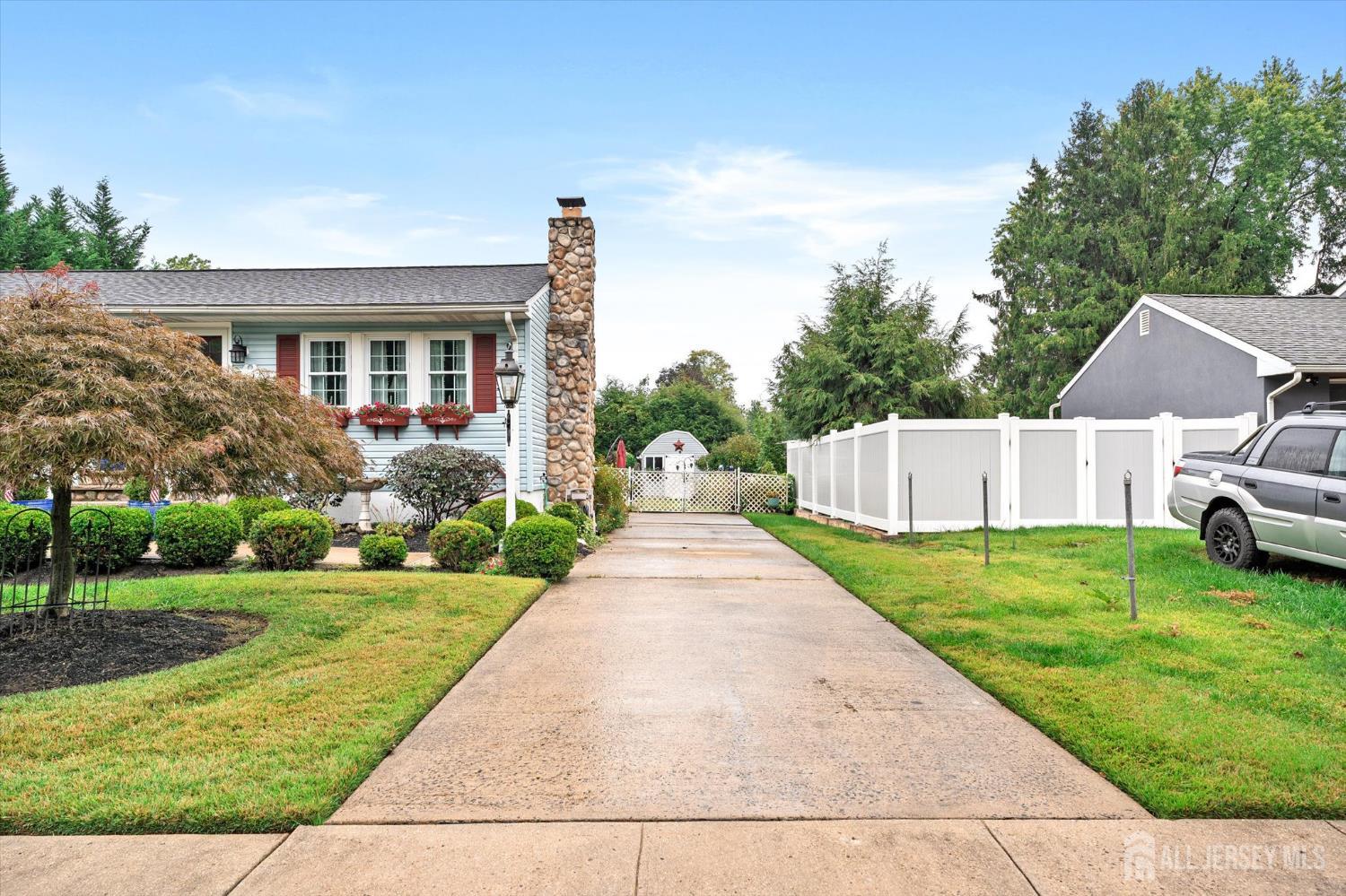 66 Rutgers Avenue Hamilton, NJ 08619 - Photo 2 of 31 a front view of a house with a yard and garage