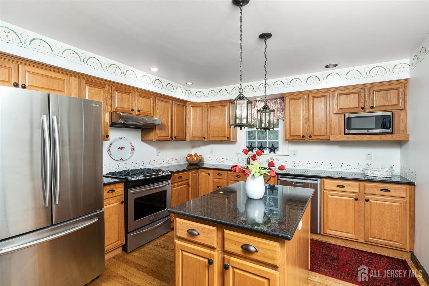 66 Rutgers Avenue Hamilton, NJ 08619 - Photo 10 of 31 a kitchen with stainless steel appliances granite countertop a sink stove and refrigerator