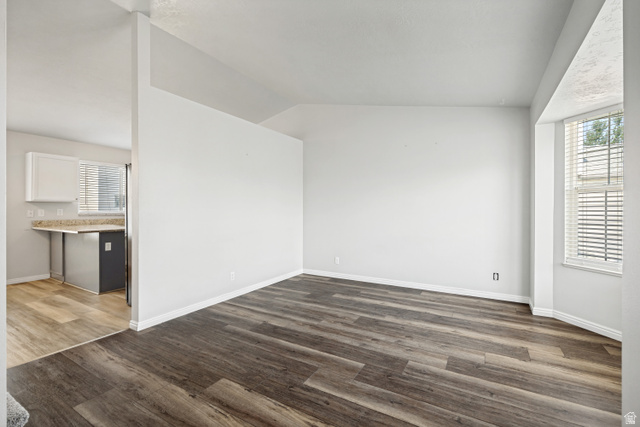 5529 Ridge Hollow Way Kearns, UT 84118 - Photo 5 of 23 Spacious room featuring wood-finish flooring and a bay window