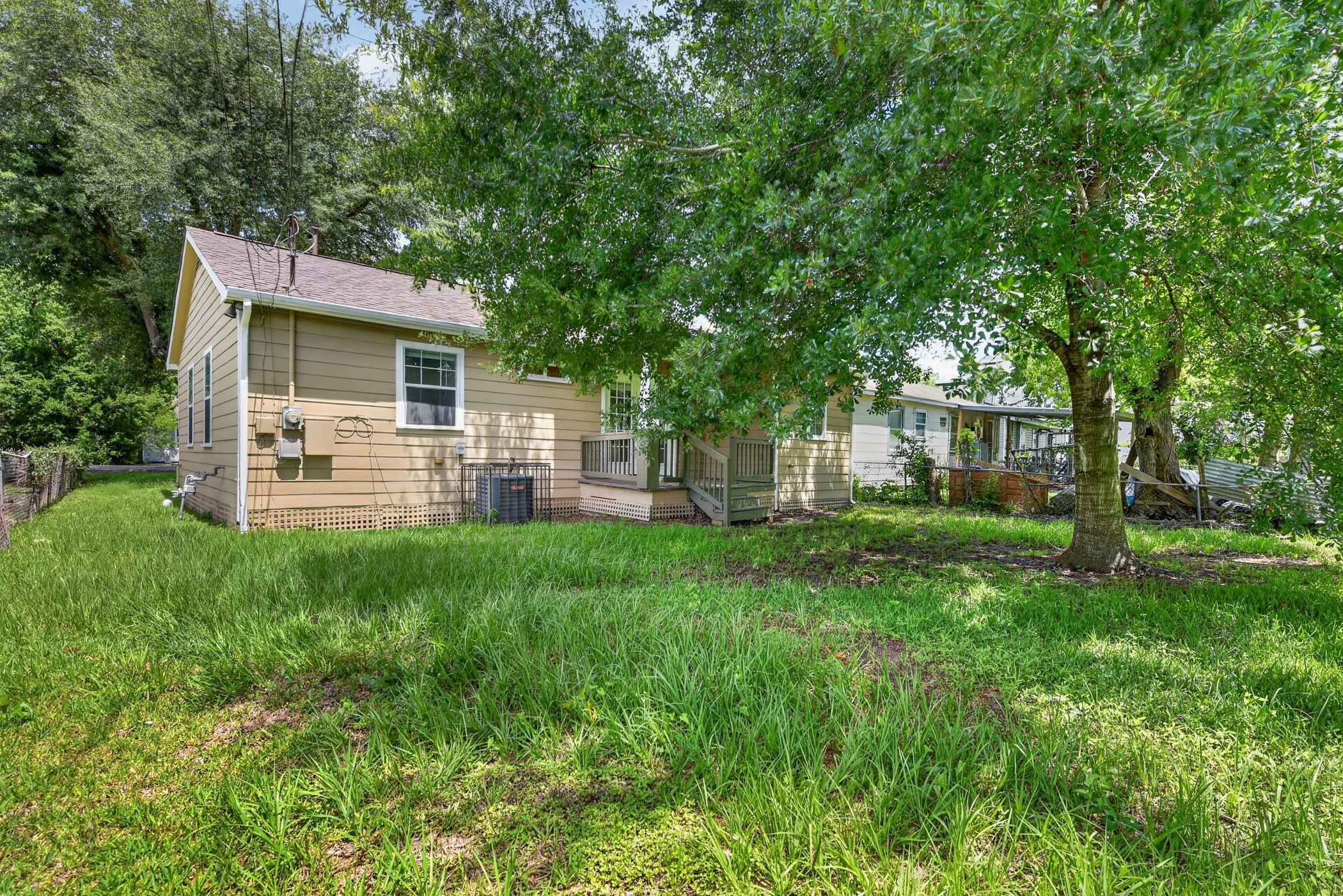 7013 St Augustine Street Houston, TX 77021 - Photo 35 of 35 a view of a backyard with table and chairs and large trees