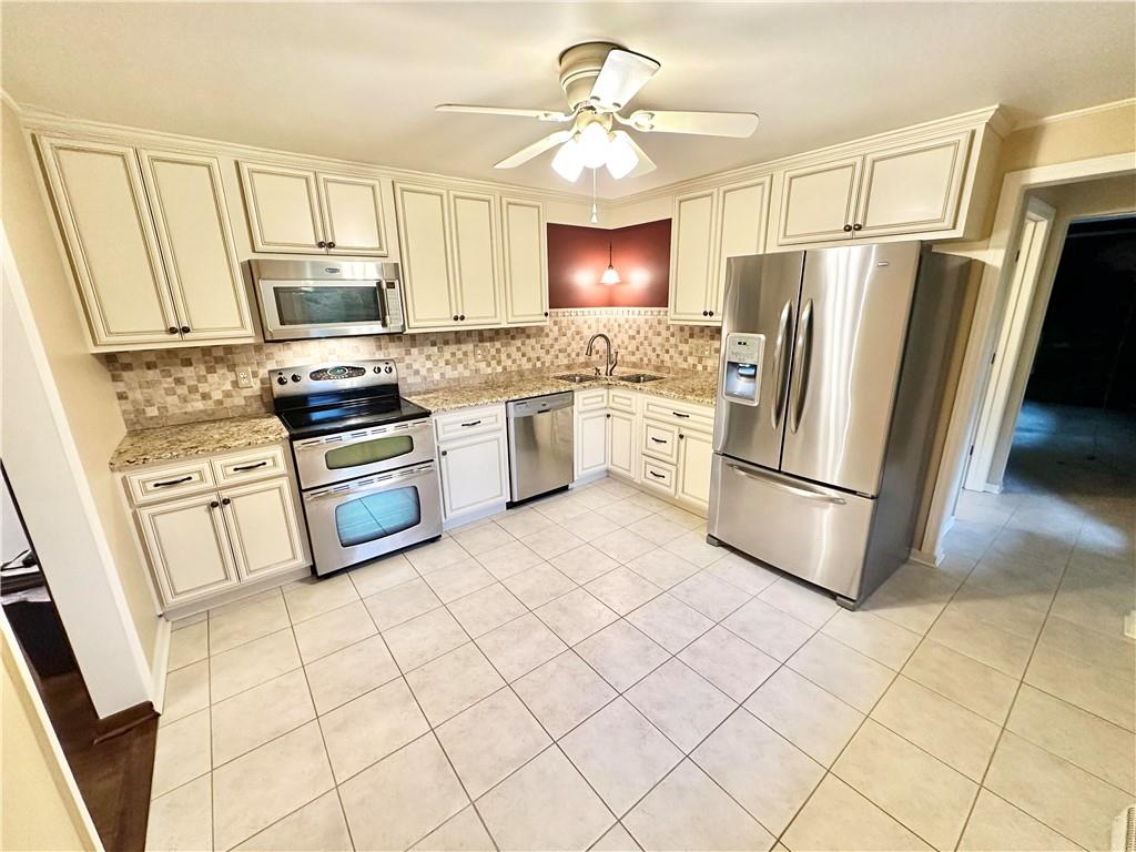 cream colored kitchen with stainless steel appliances