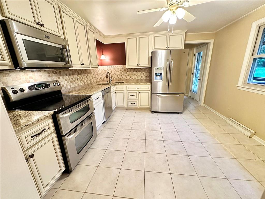 granite counter tops and tiled backsplash