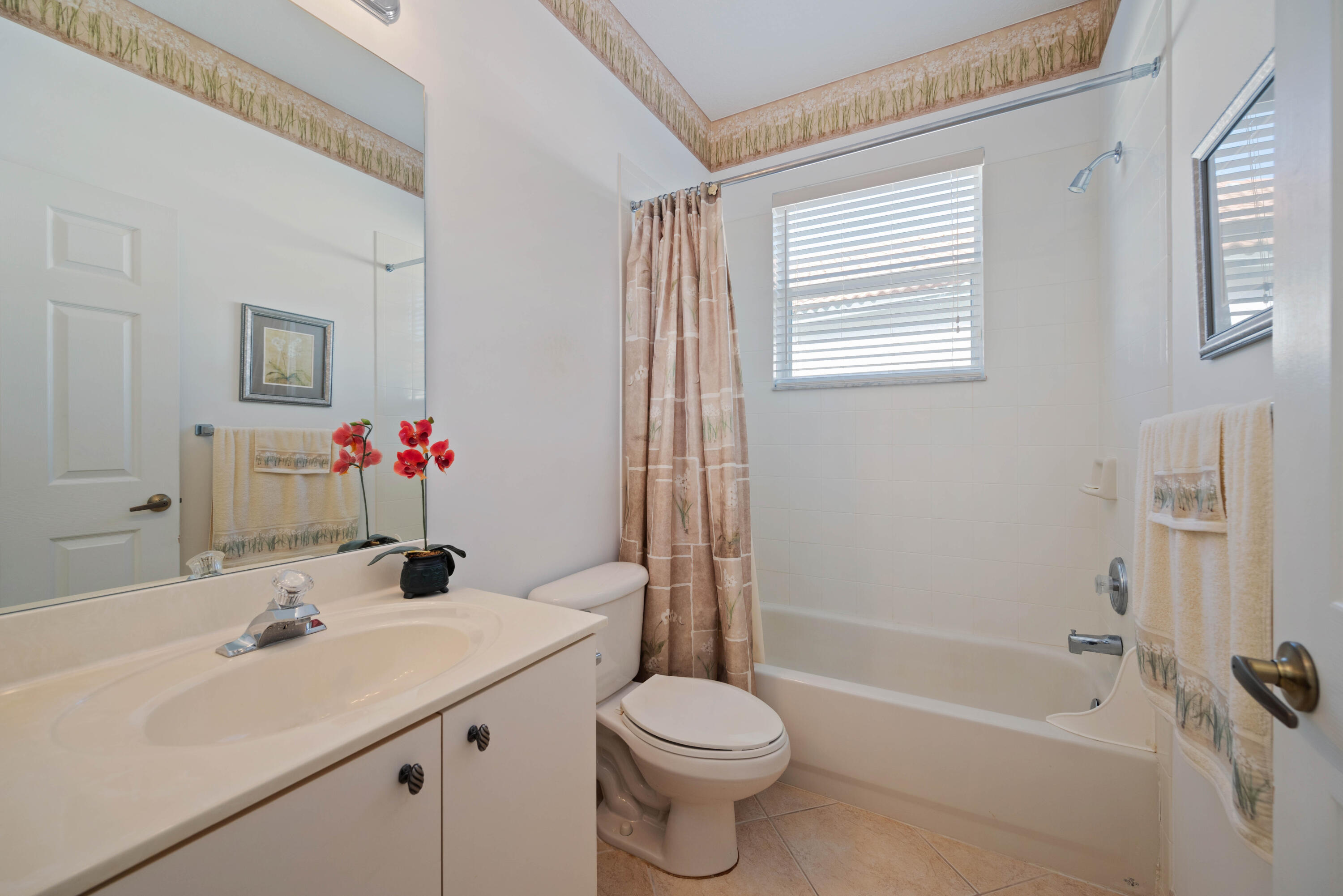 2096 Northwest Marsh Rabbit Lane Jensen Beach, FL 34957 - Photo 11 of 38 a bathroom with a sink toilet and shower
