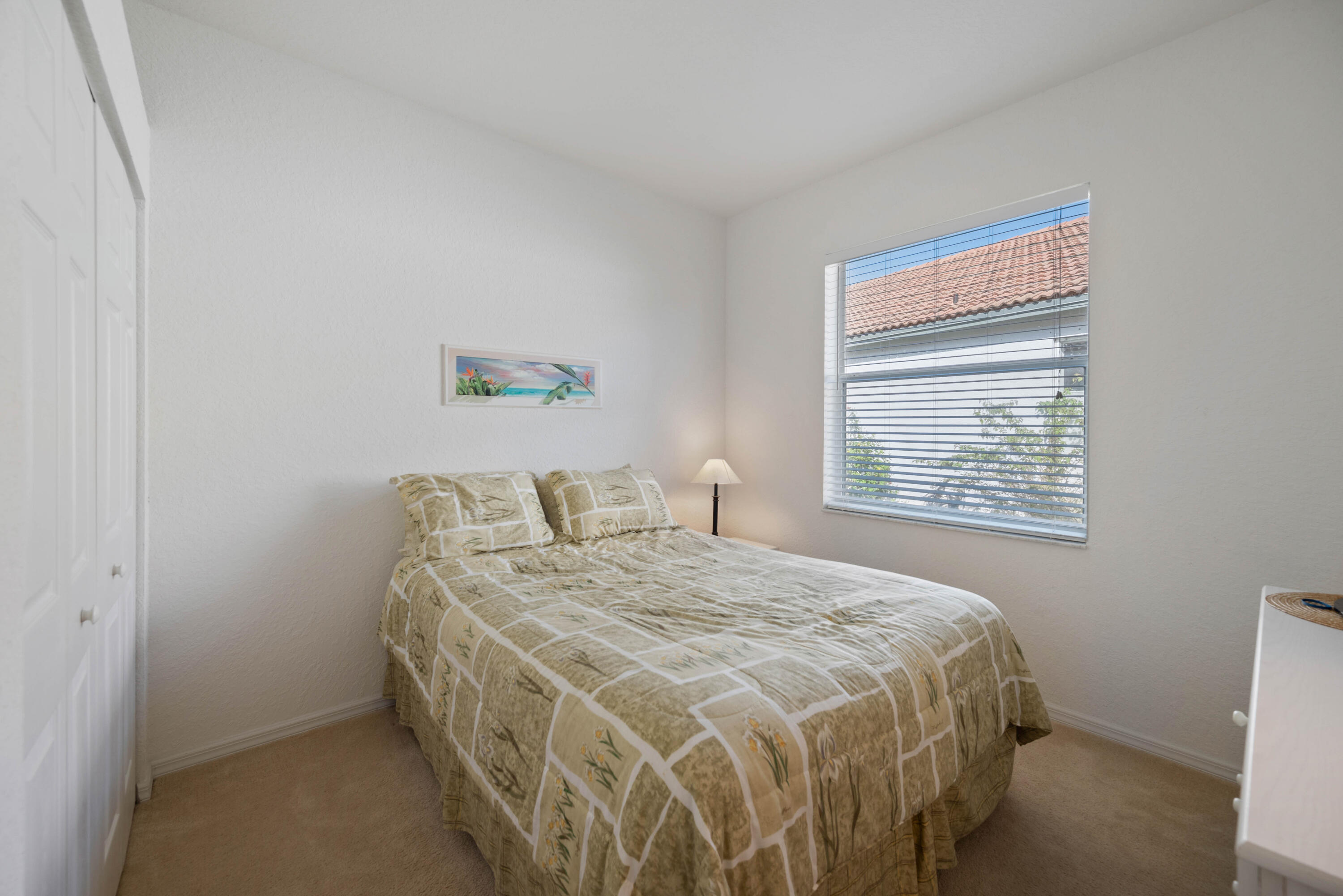 2096 Northwest Marsh Rabbit Lane Jensen Beach, FL 34957 - Photo 12 of 38 a bedroom with a bed and a window