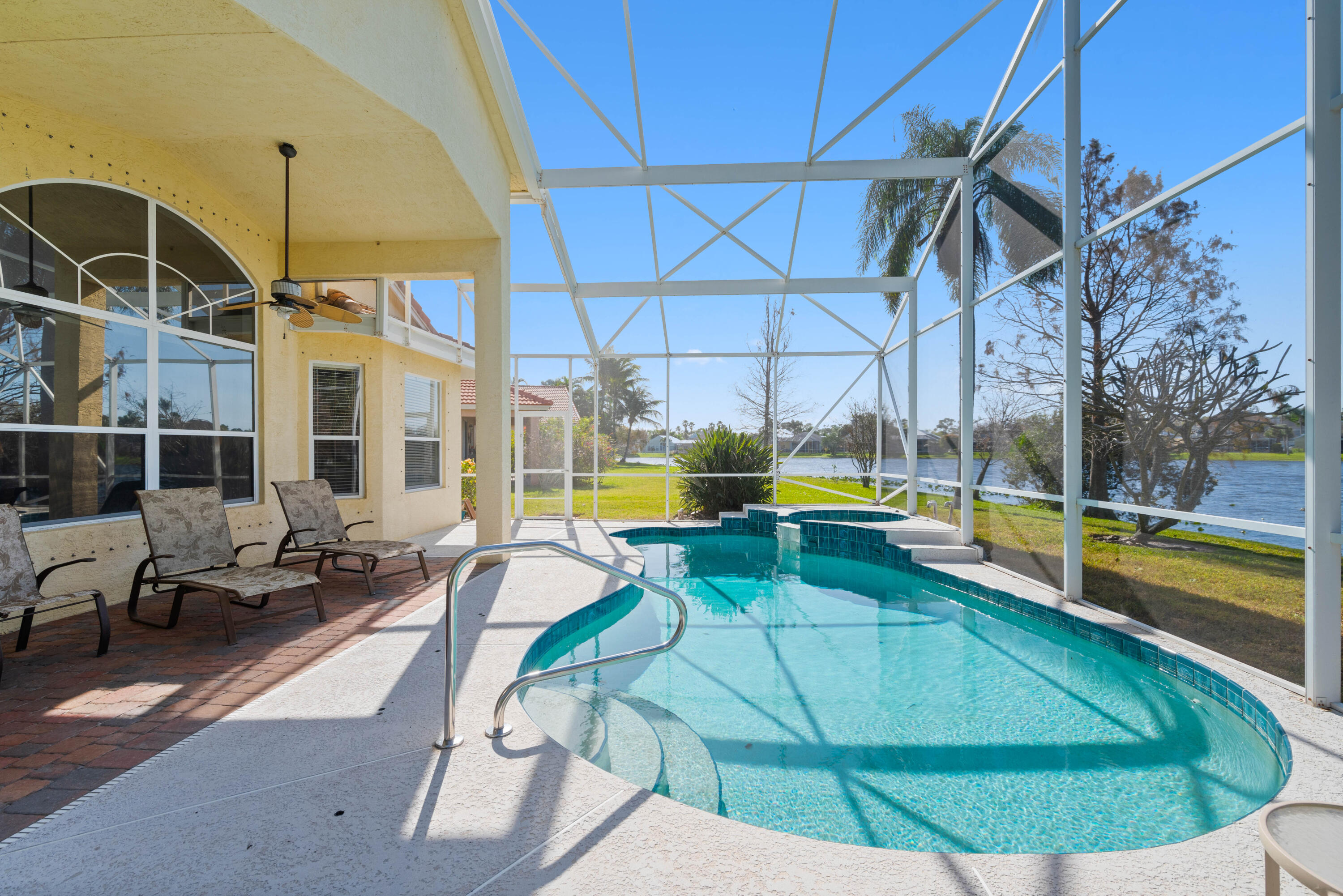 2096 Northwest Marsh Rabbit Lane Jensen Beach, FL 34957 - Photo 2 of 38 a view of a swimming pool with seating area