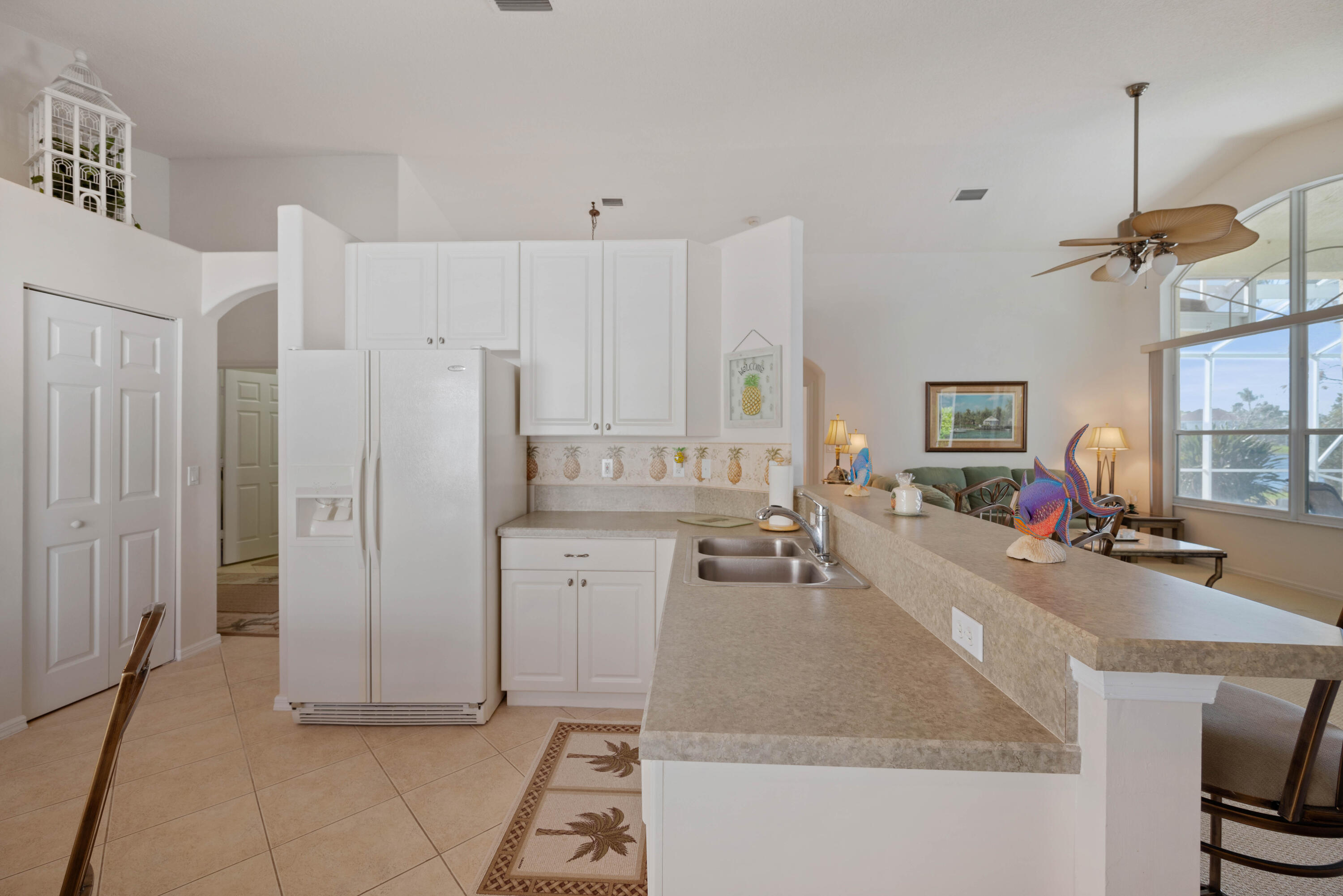 2096 Northwest Marsh Rabbit Lane Jensen Beach, FL 34957 - Photo 21 of 38 a kitchen with refrigerator and window