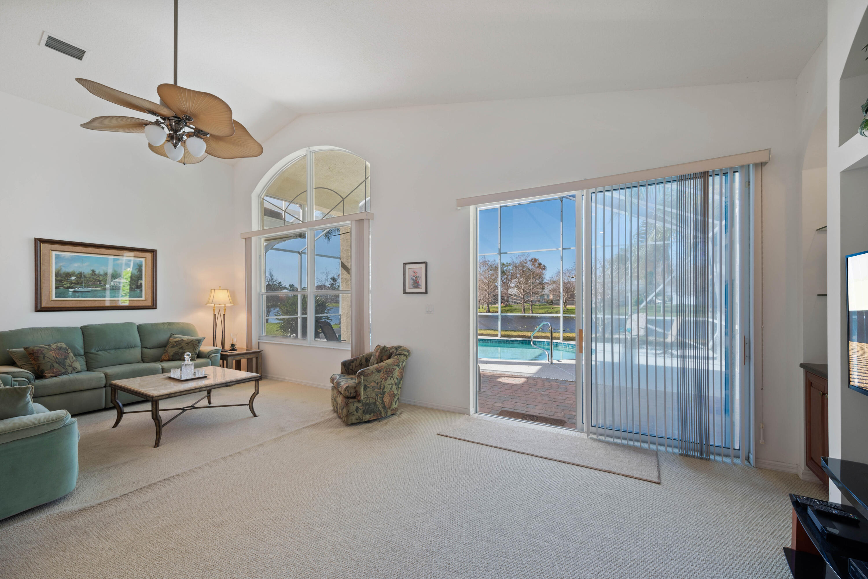 2096 Northwest Marsh Rabbit Lane Jensen Beach, FL 34957 - Photo 22 of 38 a living room with furniture a chandelier and a window