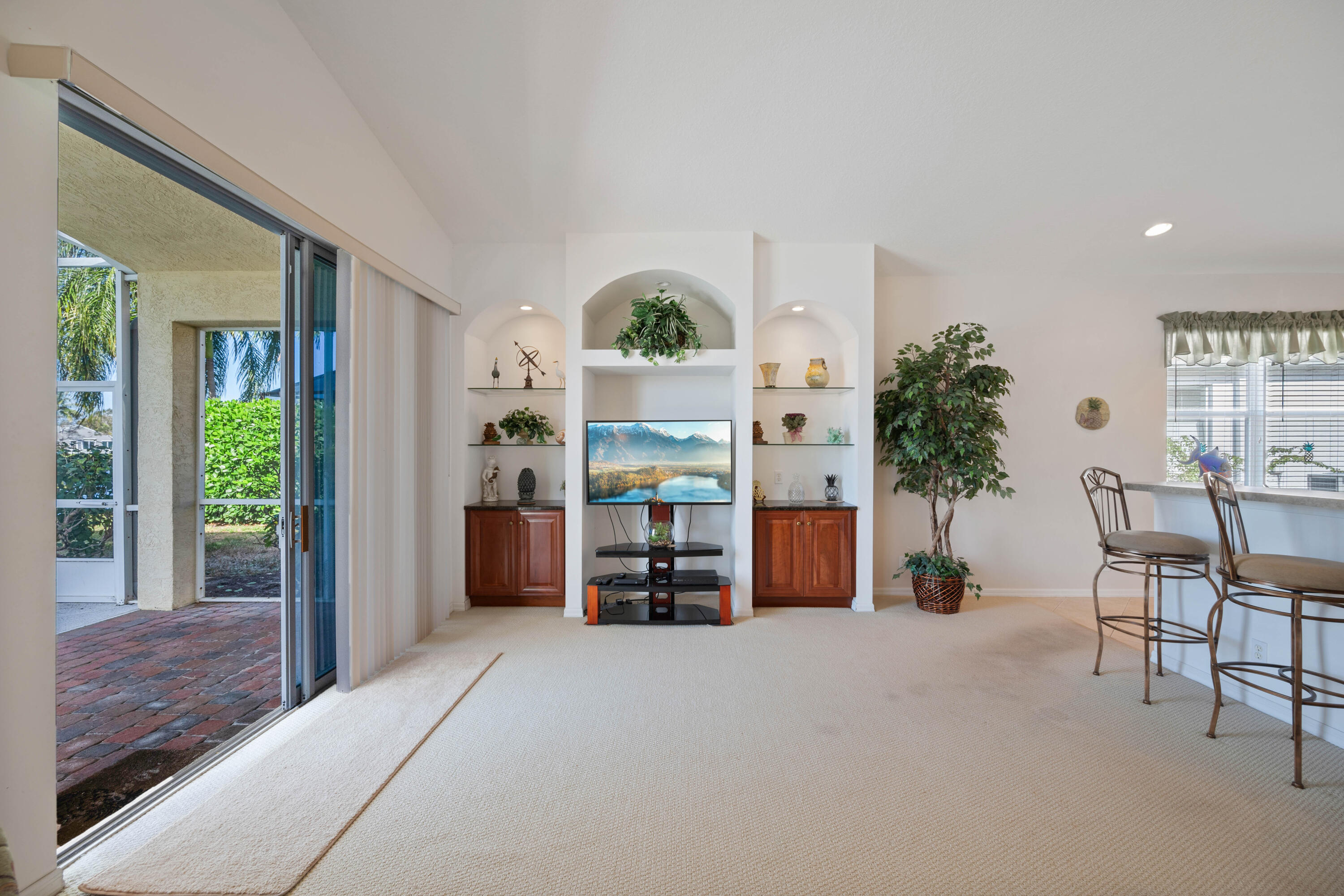 2096 Northwest Marsh Rabbit Lane Jensen Beach, FL 34957 - Photo 24 of 38 a living room with furniture a potted plant and a large window