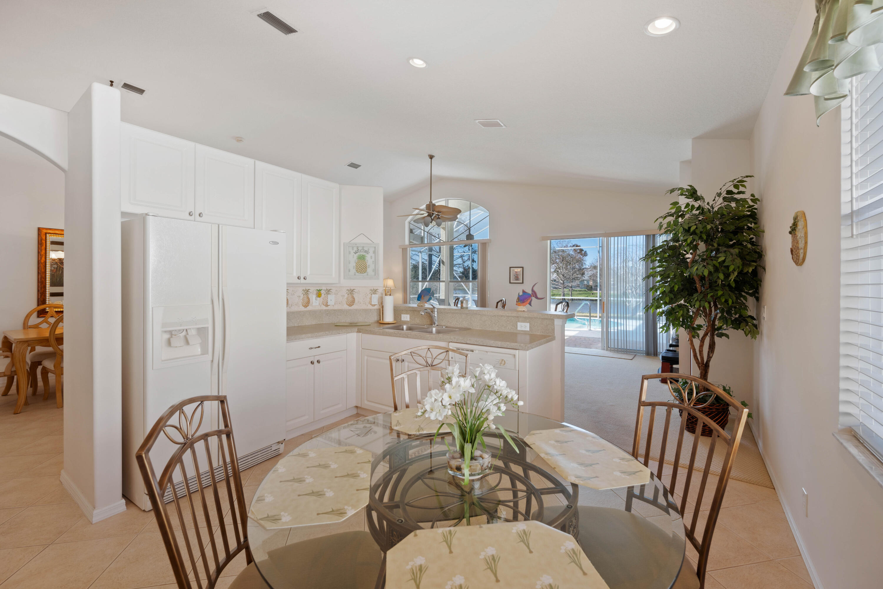 2096 Northwest Marsh Rabbit Lane Jensen Beach, FL 34957 - Photo 26 of 38 a view of a dining room with furniture window and wooden floor
