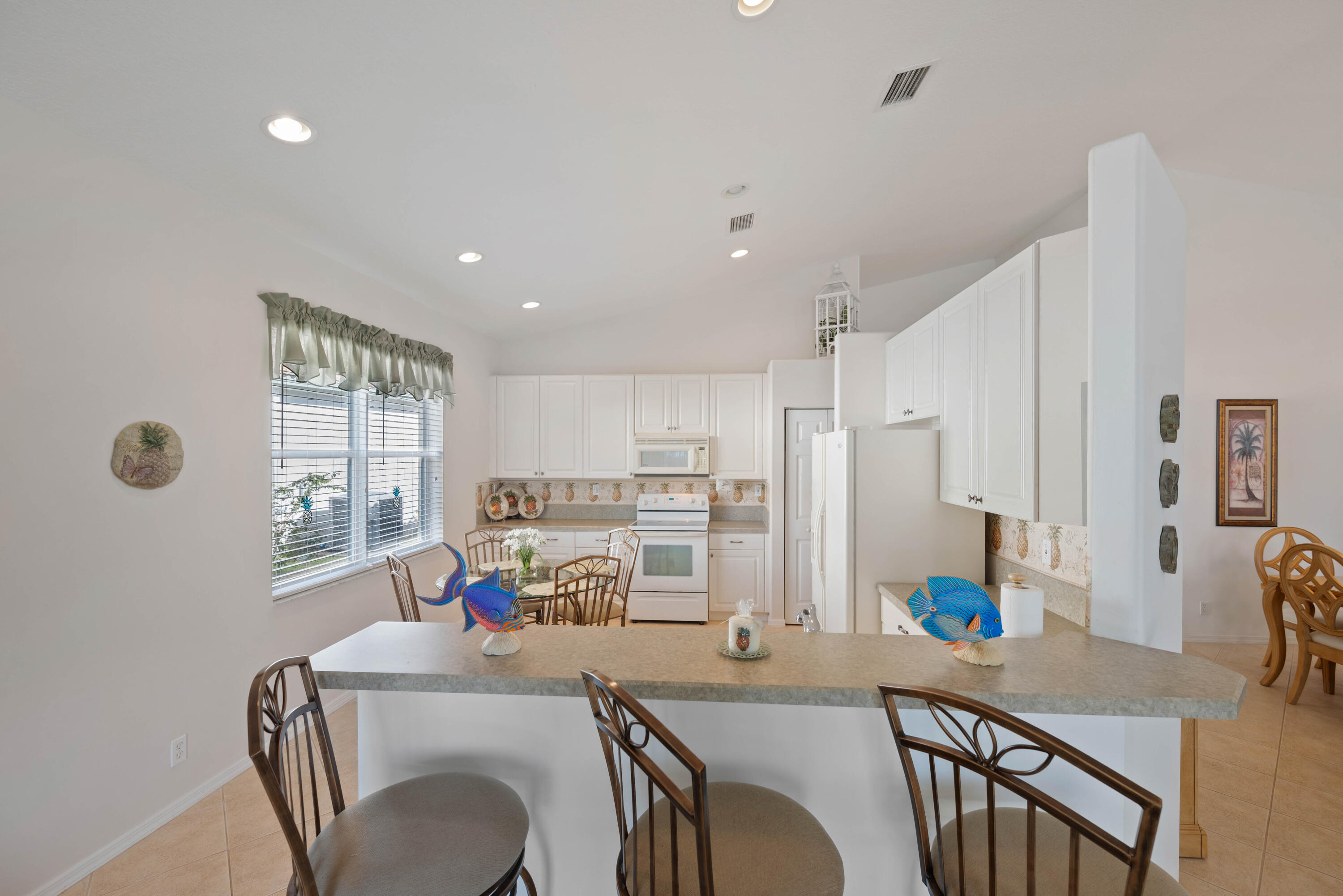 2096 Northwest Marsh Rabbit Lane Jensen Beach, FL 34957 - Photo 27 of 38 a dining room with furniture and window