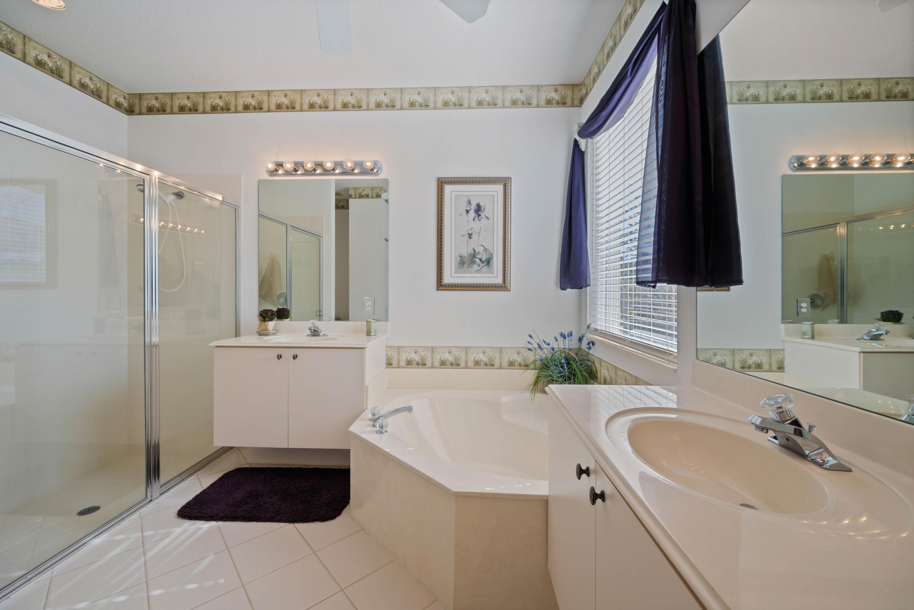 2096 Northwest Marsh Rabbit Lane Jensen Beach, FL 34957 - Photo 30 of 38 a bathroom with a sink and a mirror