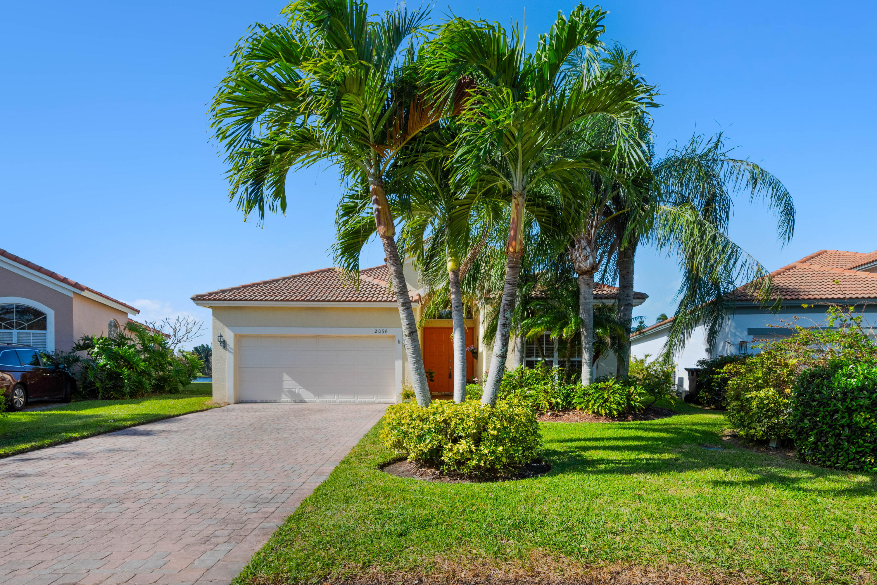 2096 Northwest Marsh Rabbit Lane Jensen Beach, FL 34957 - Photo 3 of 38 a front view of house with yard and green space