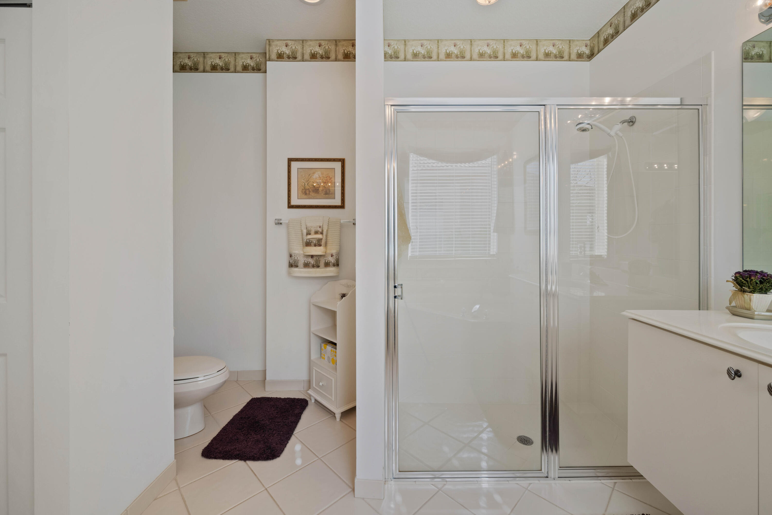 2096 Northwest Marsh Rabbit Lane Jensen Beach, FL 34957 - Photo 31 of 38 a bathroom with a granite countertop sink a toilet and shower