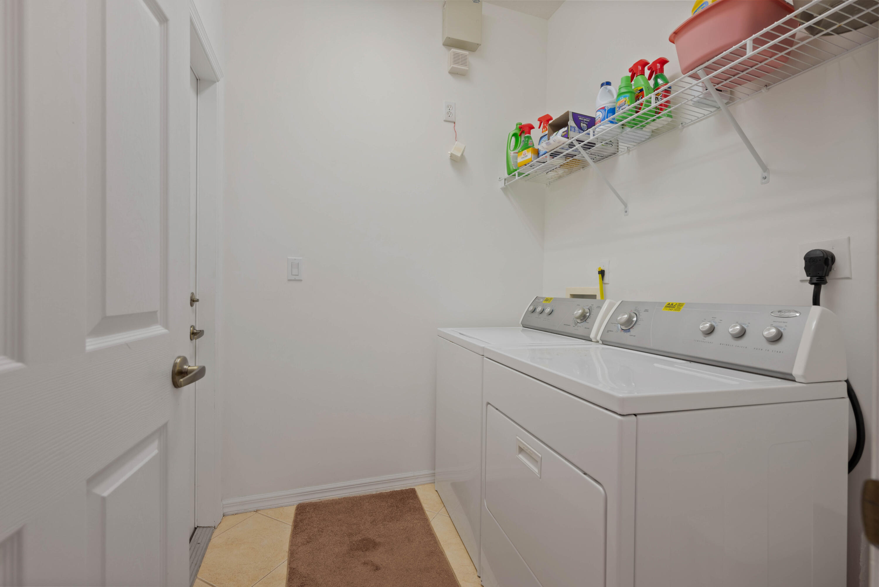 2096 Northwest Marsh Rabbit Lane Jensen Beach, FL 34957 - Photo 32 of 38 a utility room with dryer and washer
