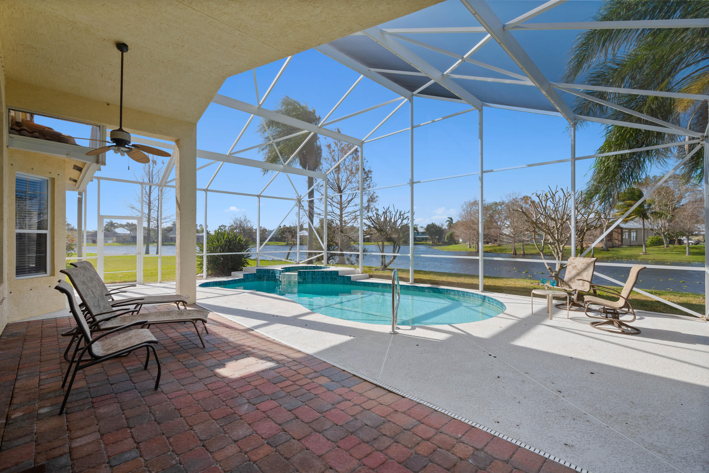 2096 Northwest Marsh Rabbit Lane Jensen Beach, FL 34957 - Photo 33 of 38 a swimming pool with outdoor seating and yard