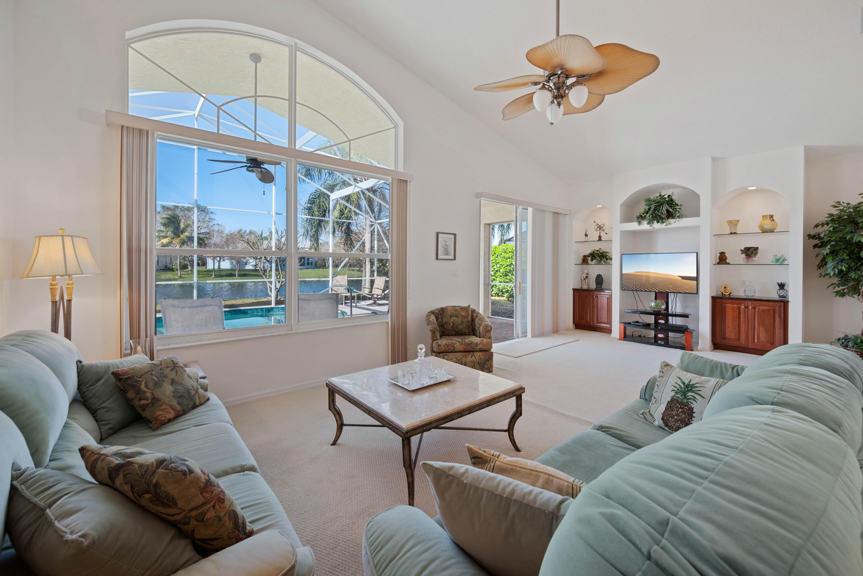 2096 Northwest Marsh Rabbit Lane Jensen Beach, FL 34957 - Photo 4 of 38 a living room with furniture a fireplace and a large window