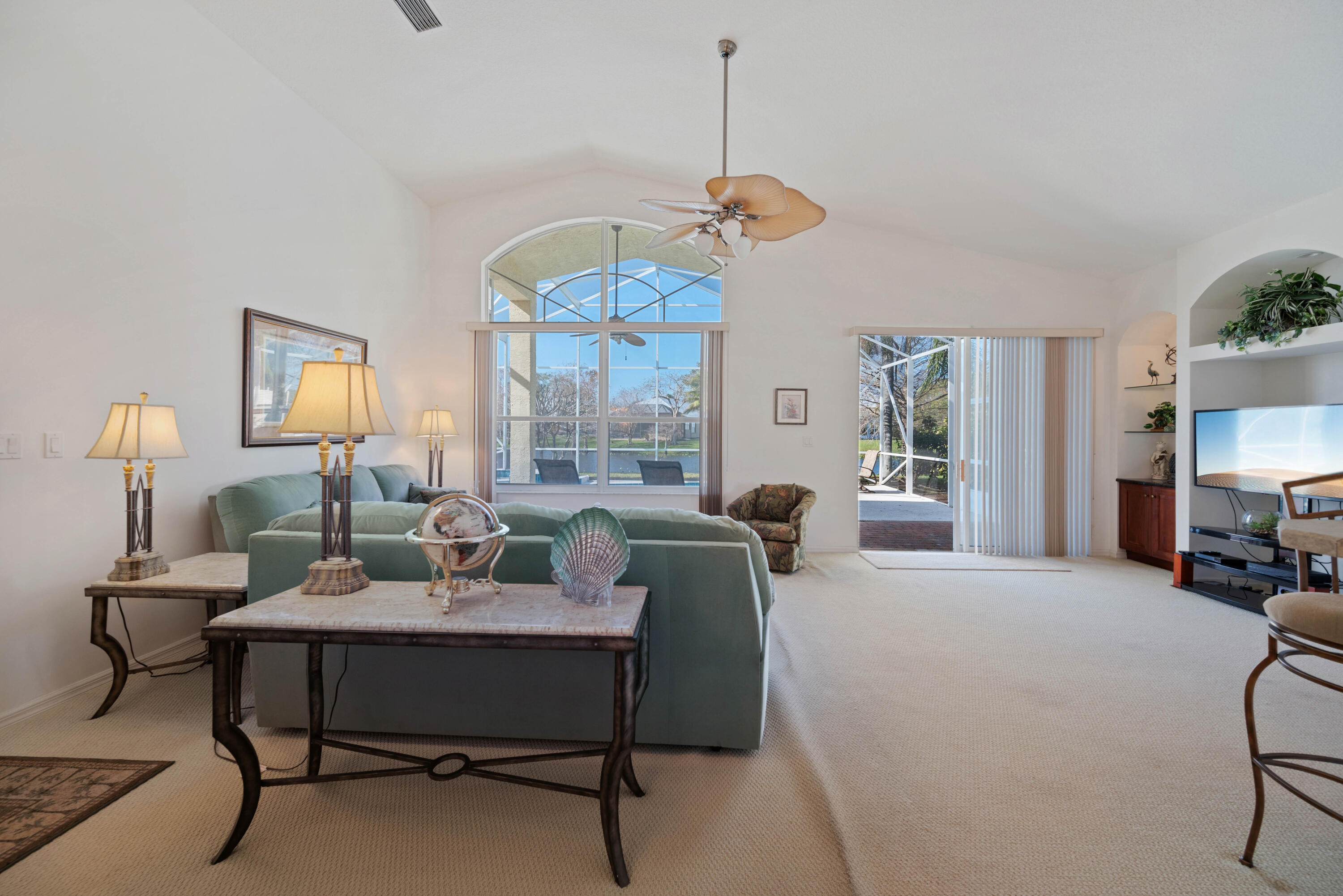 2096 Northwest Marsh Rabbit Lane Jensen Beach, FL 34957 - Photo 8 of 38 a living room with furniture a chandelier and a window