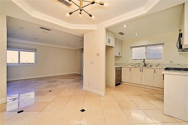 a view of a kitchen with a sink dishwasher refrigerator and cabinets