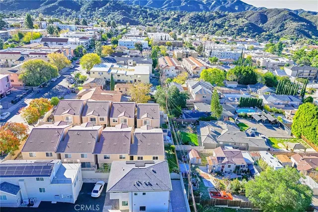 an aerial view of a houses with a swimming pool