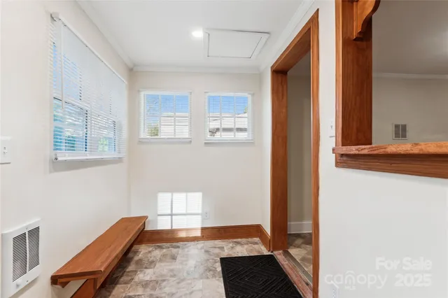 a view of a bedroom with furniture and windows
