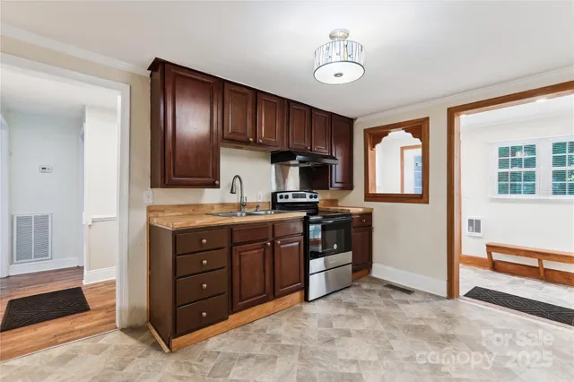 a kitchen with stainless steel appliances granite countertop a refrigerator and a stove top oven