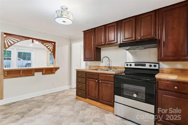a kitchen with stainless steel appliances granite countertop a stove and a microwave