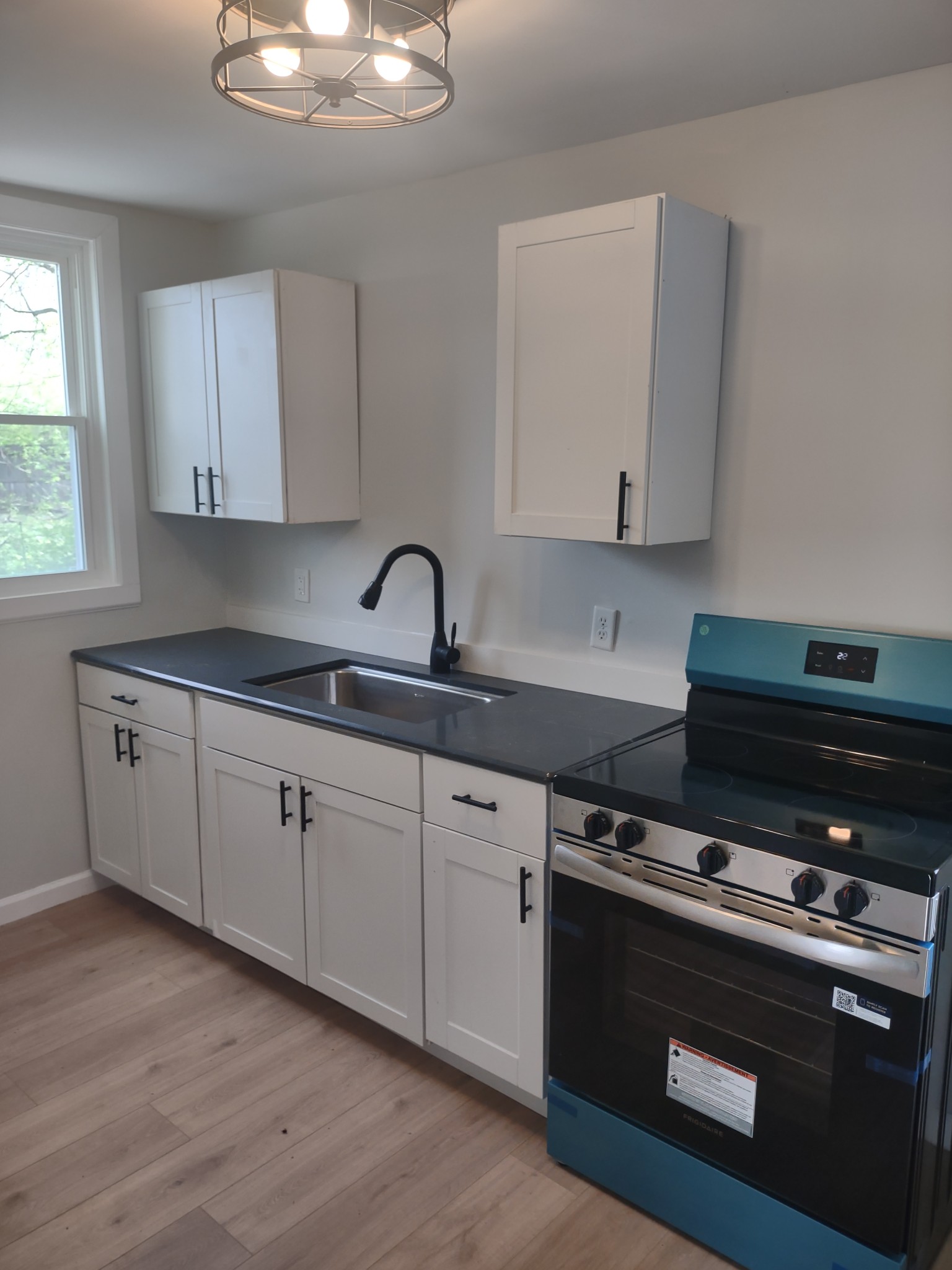 143 Morrison Street, Unit 3 Gallatin, TN 37066 - Photo 2 of 11 a kitchen with stainless steel appliances a stove a sink and white cabinets