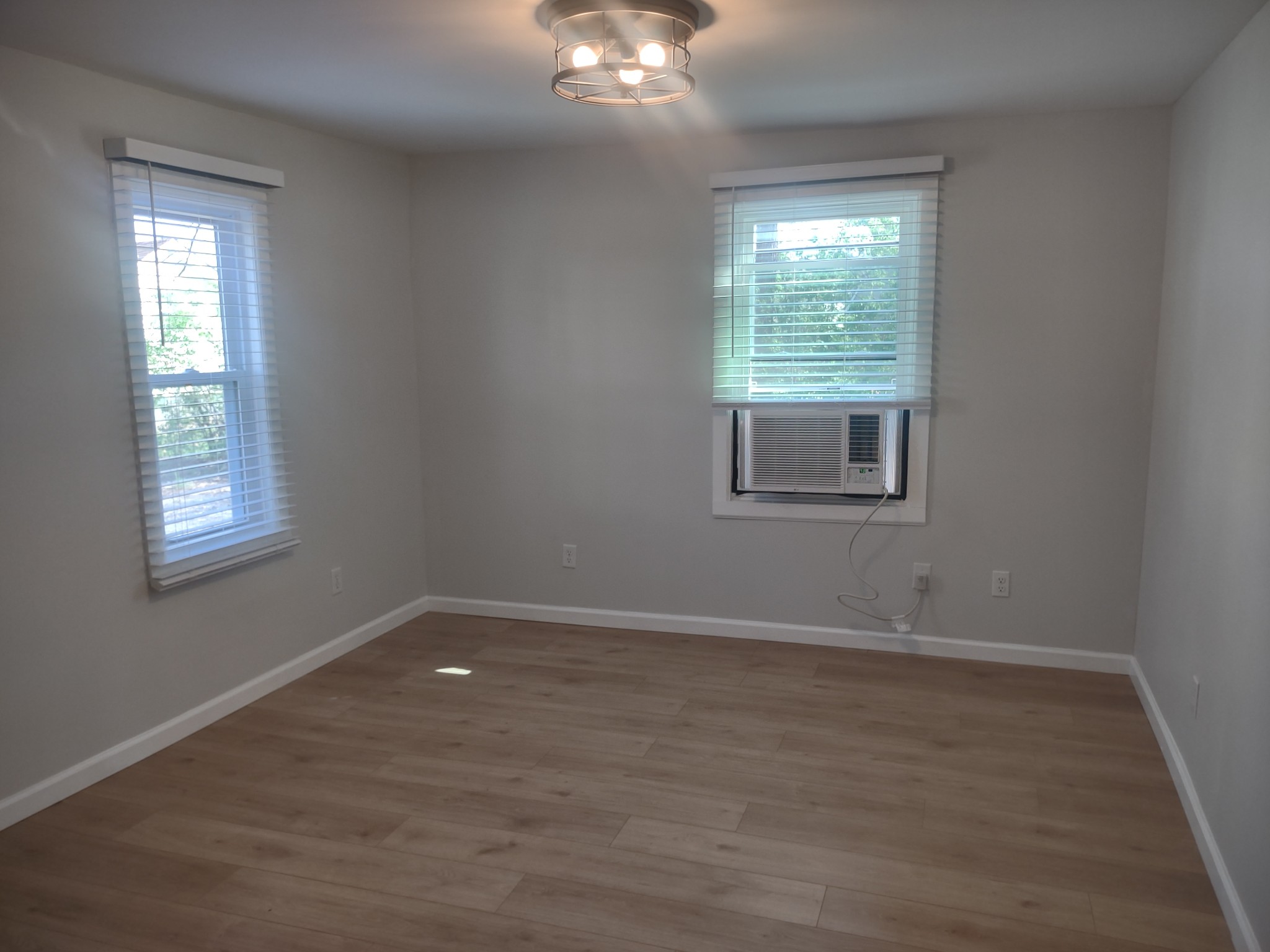 143 Morrison Street, Unit 3 Gallatin, TN 37066 - Photo 7 of 11 a view of an empty room with wooden floor and a window
