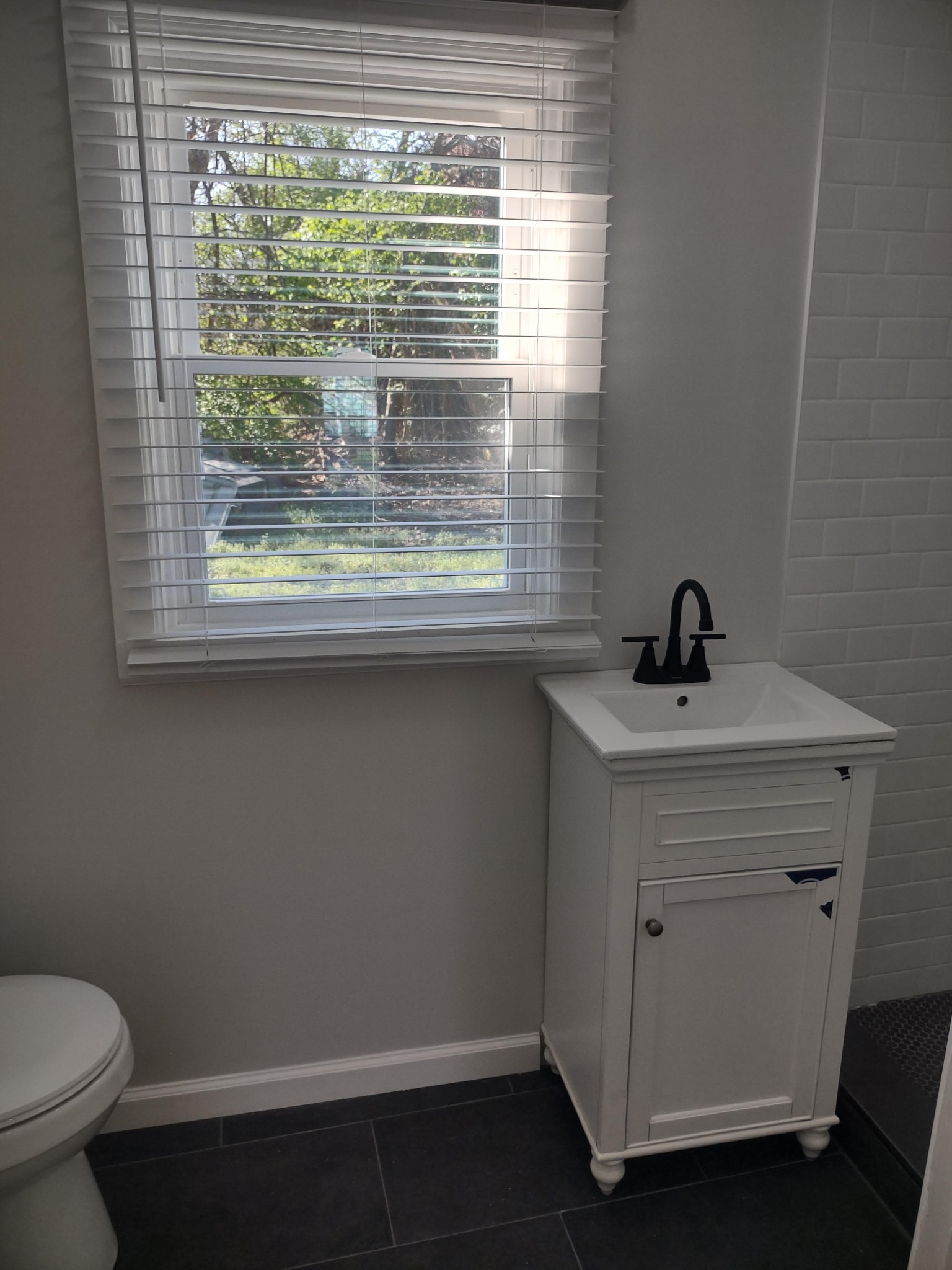143 Morrison Street, Unit 3 Gallatin, TN 37066 - Photo 8 of 11 a bathroom with a sink a toilet and a window