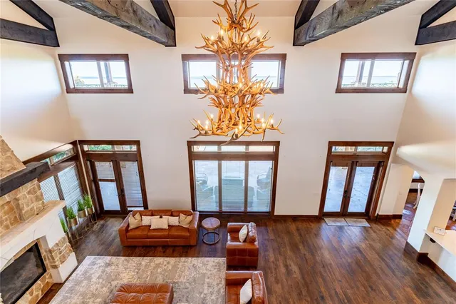 a large kitchen with kitchen island a sink stainless steel appliances and a large window