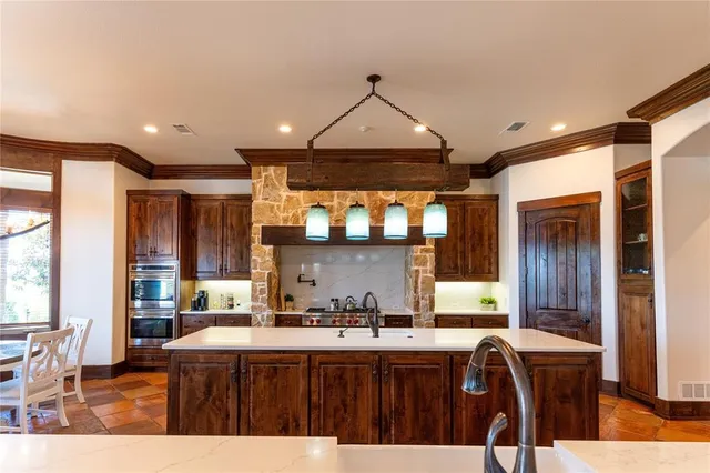 a kitchen with granite countertop a oven and cabinets
