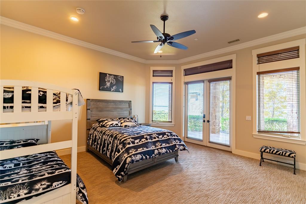 1180 McReynolds Road Sanger, TX 76266 - Photo 18 of 36 a bedroom with a bed and a chandelier