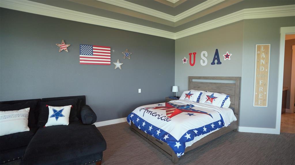 1180 McReynolds Road Sanger, TX 76266 - Photo 23 of 36 a bedroom with a bed and a couch