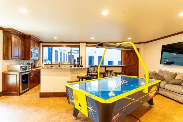 a kitchen with kitchen island granite countertop a sink and a counter top space