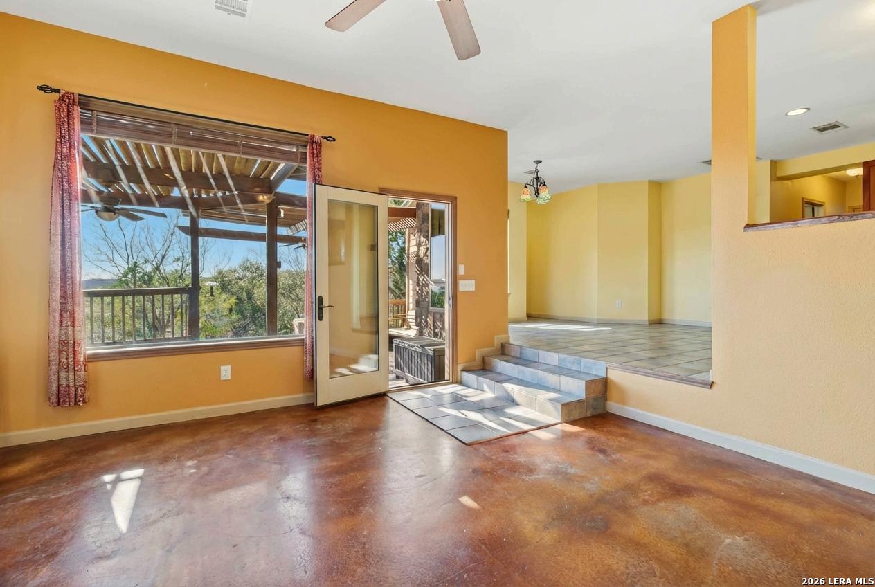 9623 Requa Road Helotes, TX 78023 - Photo 11 of 49 a view of a livingroom with wooden floor and a large window