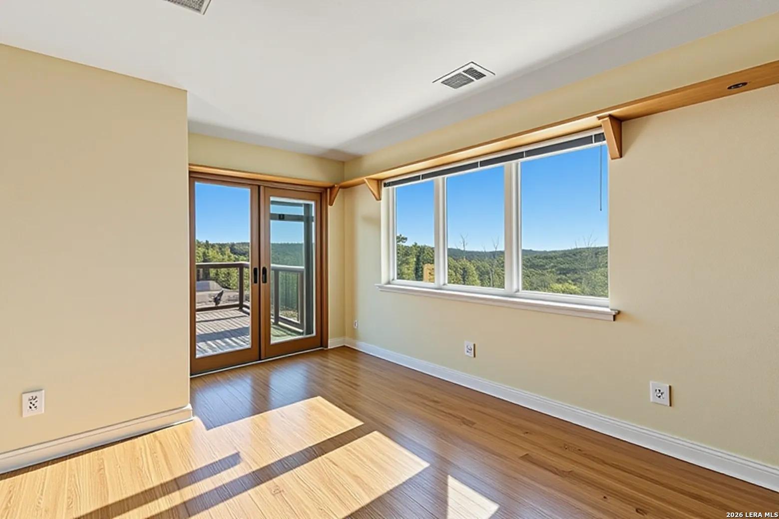 9623 Requa Road Helotes, TX 78023 - Photo 30 of 49 a view of an empty room with window and wooden floor